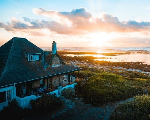 House by the sea with a sunset view in the distance